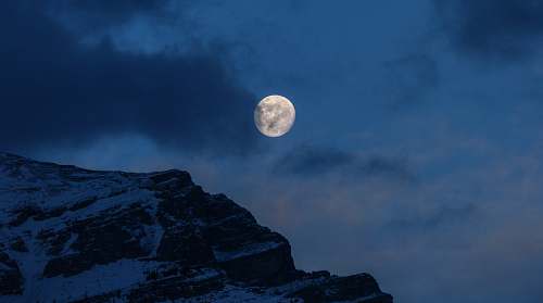 full moon snowy mountain under full moon during nighttime space
